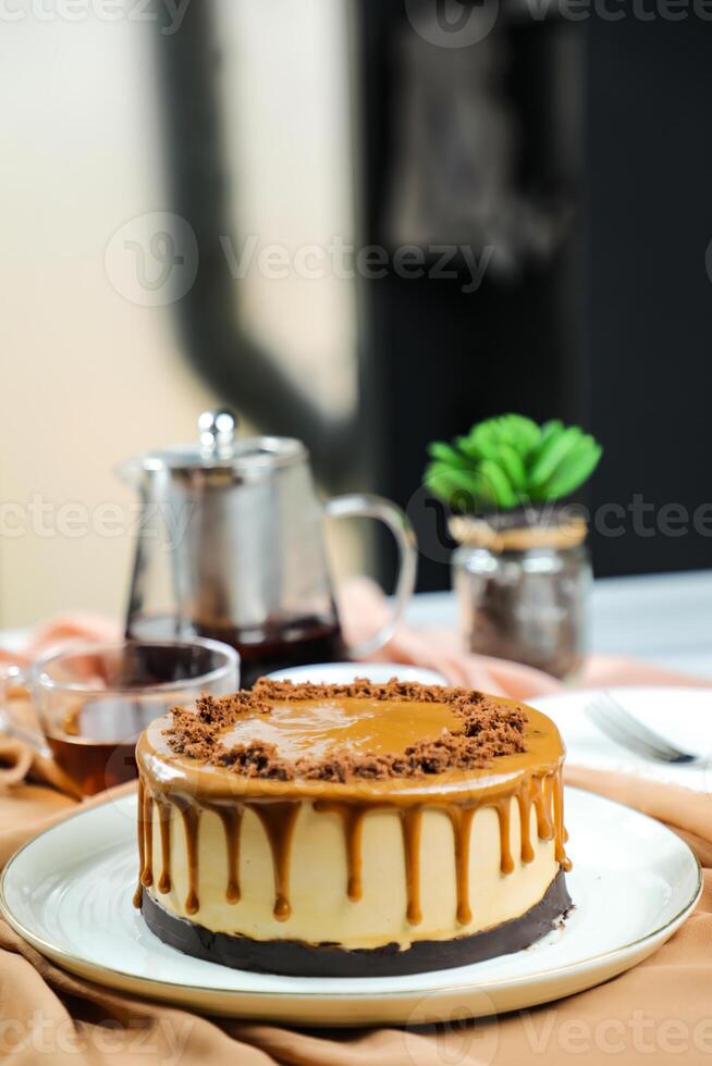 salé caramel blondie gâteau comprendre Chocolat crème, sucre avec fourchette, tasse de café et pot servi sur planche isolé sur serviette de table côté vue de café nourriture photo
