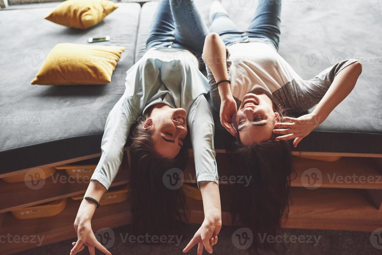 deux belles jeunes sœurs jumelles passent du temps avec des oreillers. frères et sœurs s'amusant à la maison concept photo