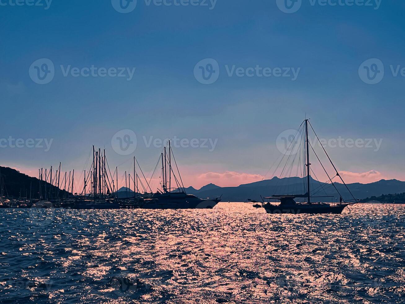 tranquille paysage marin et côtier la nature concept. mer, bateaux, montagnes et bleu ciel plus de horizon à le coucher du soleil photo