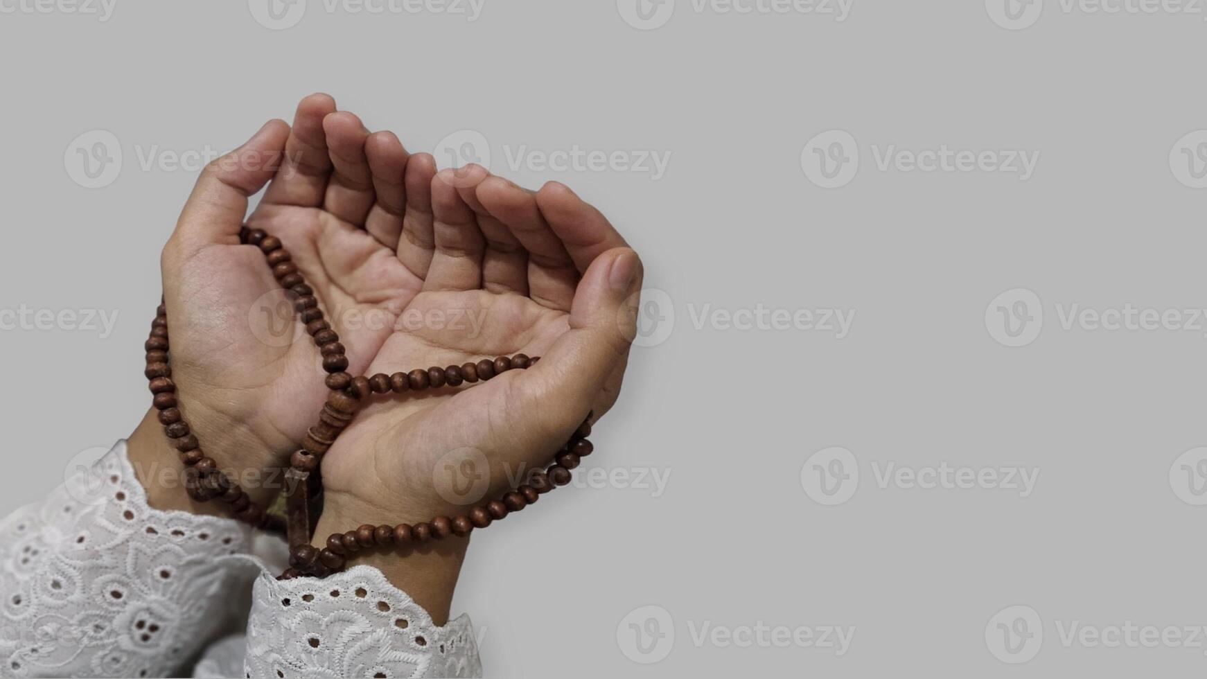 musulman prier mains en portant prière perles dans Ramadan, isolé gris Contexte photo