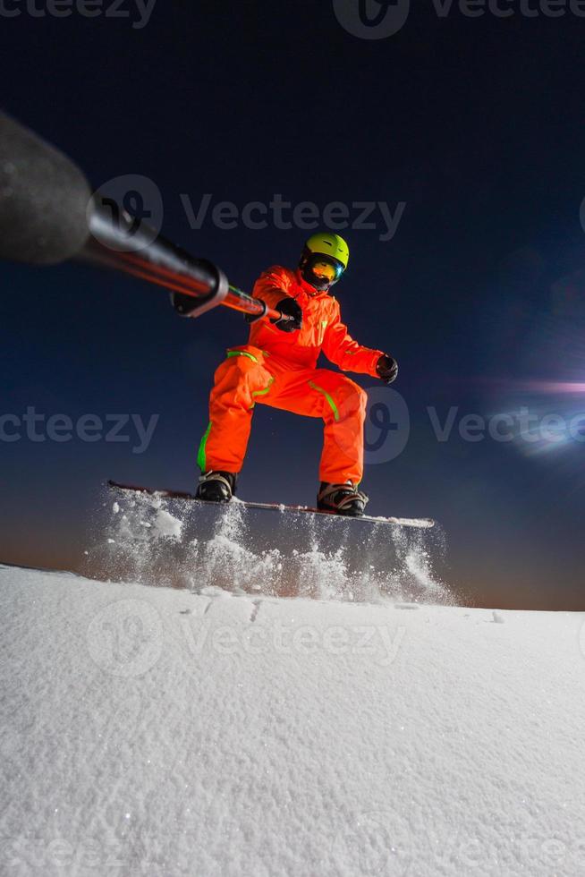 snowboarder faisant un selfie par sa caméra d'action sur le dessus de la piste de ski photo