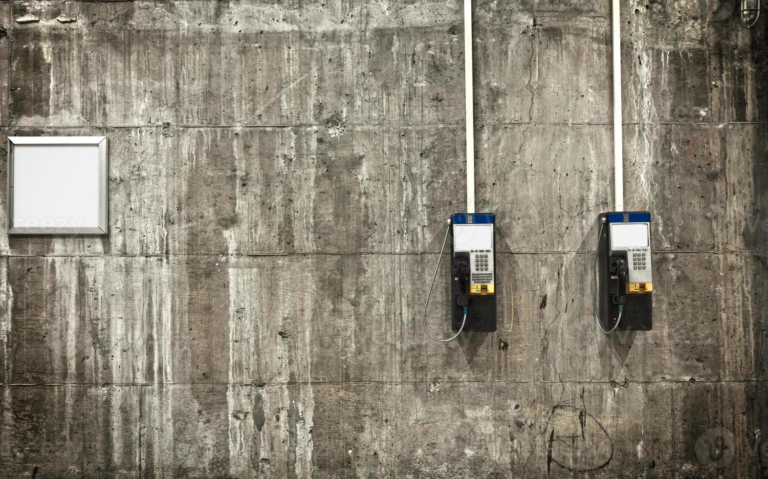 téléphones publics sur mur de béton photo