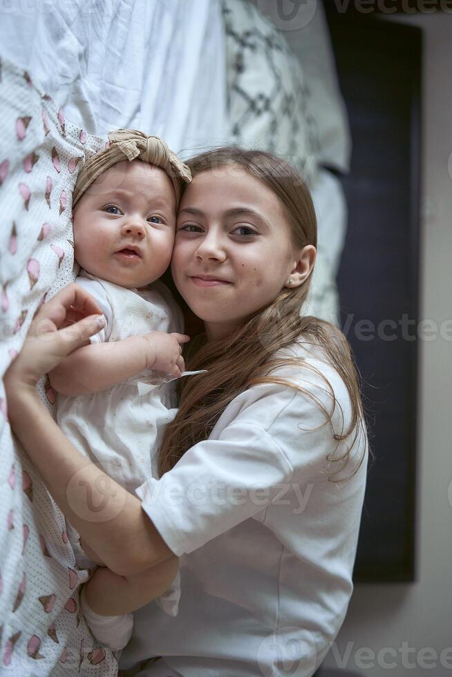 fille câlins avec sa bébé sœur photo