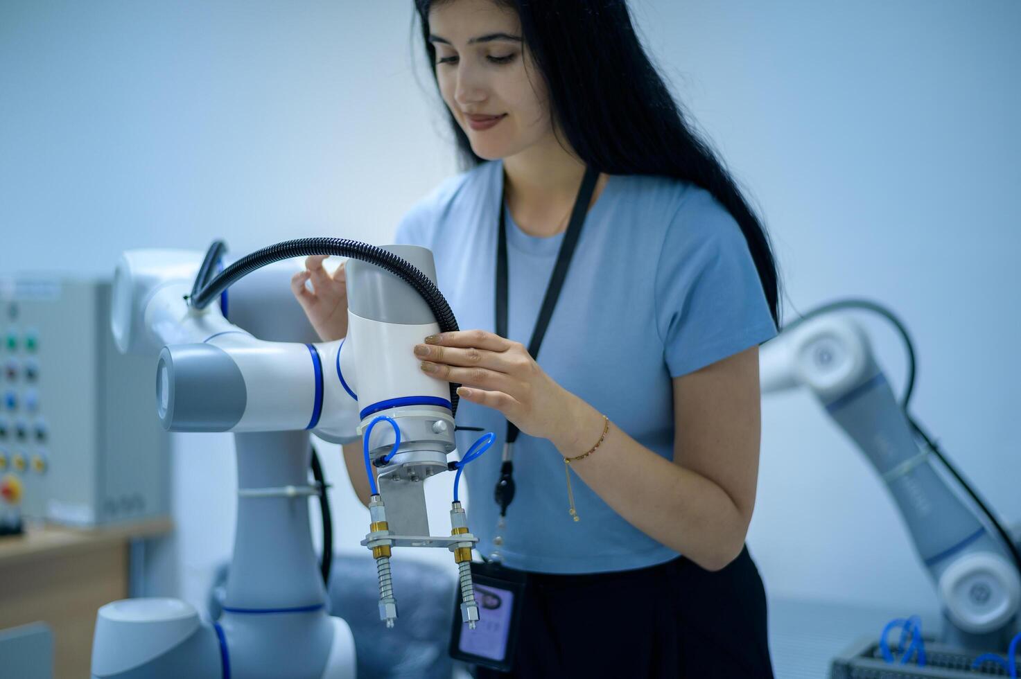 femelle la robotique ingénieur travail avec programmation et manipuler robot main, industriel la robotique conception, haute technologie facilité, moderne machine apprentissage. Masse production automatiques. photo