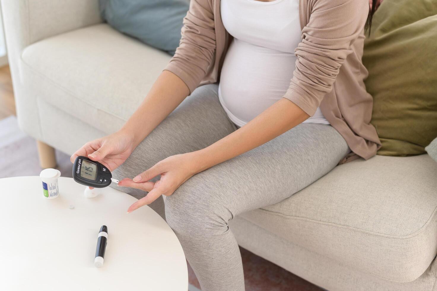 Enceinte femme vérification du sang sucre niveau par en utilisant numérique glucose mètre, santé se soucier, médecine, diabète, glycémie concept photo