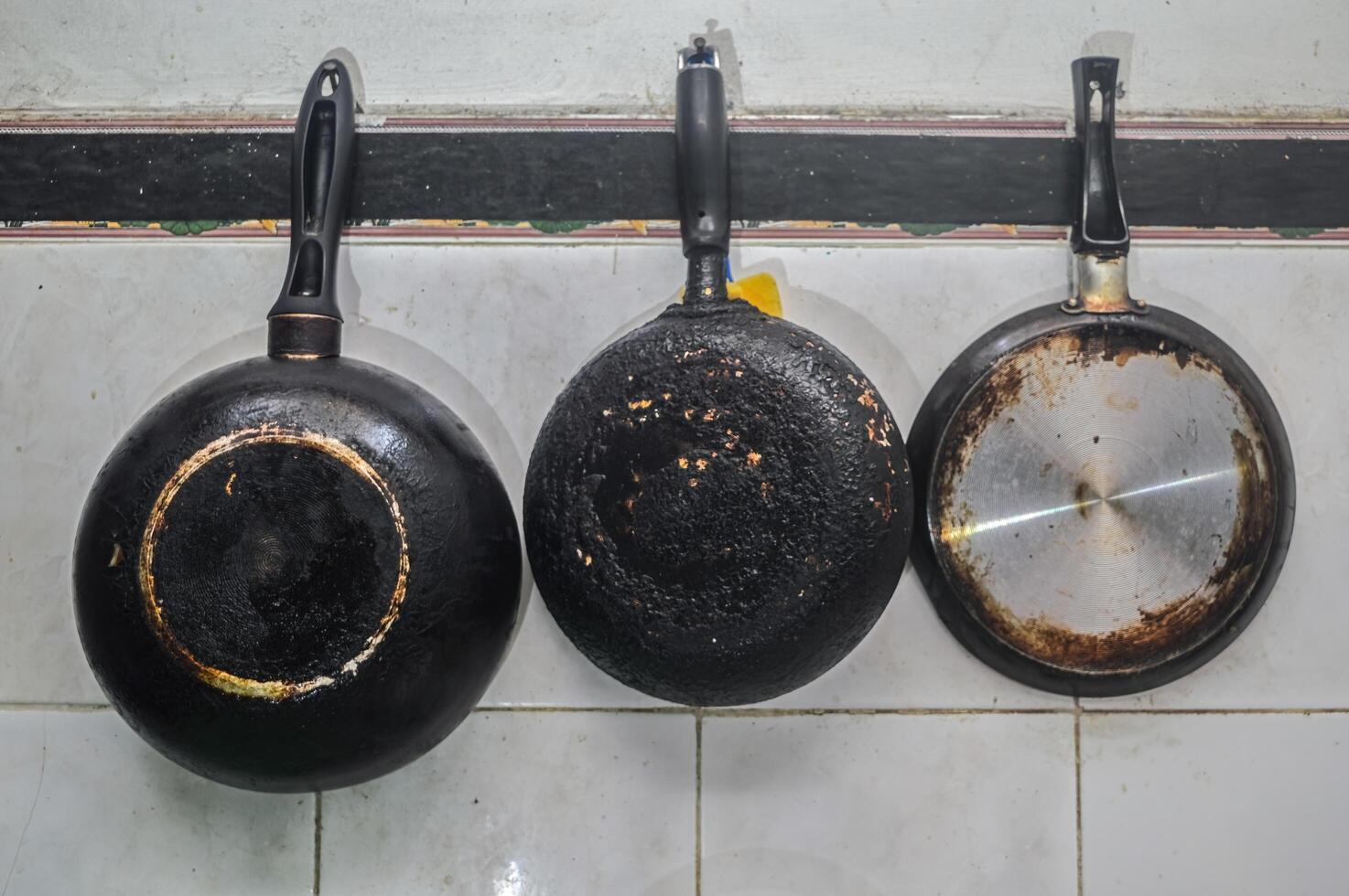 Trois téflon ou friture des casseroles pendaison dans le cuisine photo