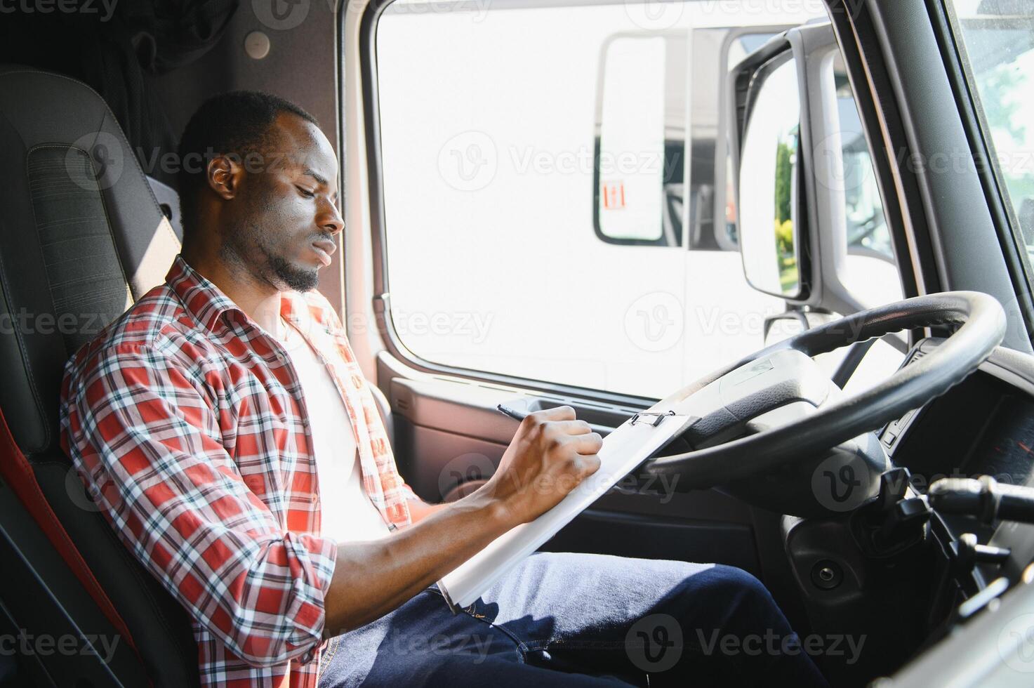 professionnel africain américain un camion chauffeur dans décontractée vêtements conduite un camion véhicule Aller pour une longue transport itinéraire. photo