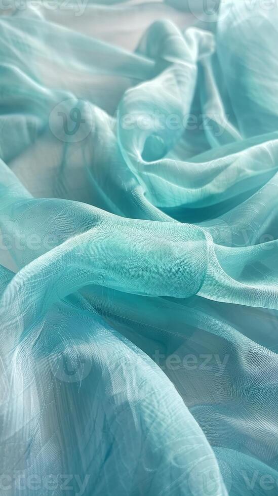 ondulant vagues de soyeux bleu vert en tissu Cascade dans sensuel plis, révélateur le somptueux texture et fluide mouvement de le matériel. photo