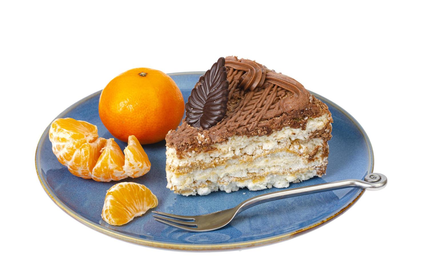 assiette avec portion de délicieux gâteau fait maison décoré de chocolat sur fond blanc. studio photo