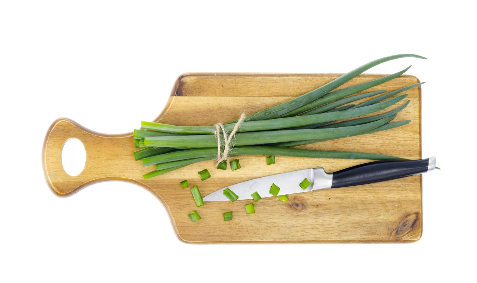 planche à découper de cuisine en bois pour trancher les oignons verts frais. photo