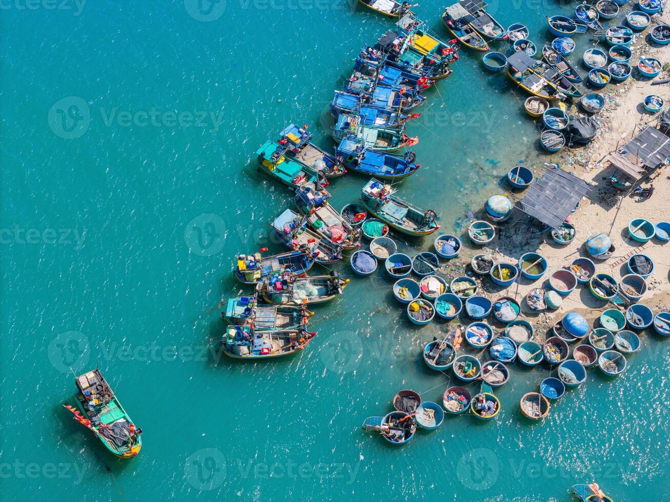 aérien vue de loc un pêche village, vung tau ville. une pêche Port avec tsunami protection béton blocs. paysage urbain et traditionnel bateaux dans le mer. photo