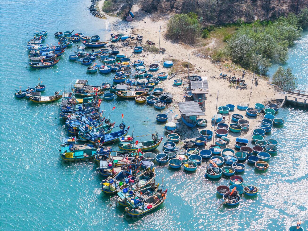 aérien vue de loc un pêche village, vung tau ville. une pêche Port avec tsunami protection béton blocs. paysage urbain et traditionnel bateaux dans le mer. photo