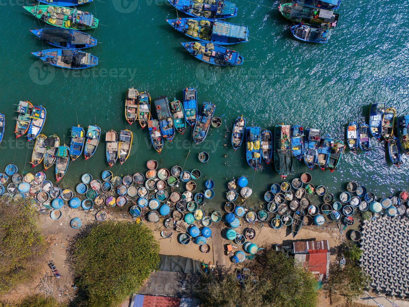aérien vue de loc un pêche village, vung tau ville. une pêche Port avec tsunami protection béton blocs. paysage urbain et traditionnel bateaux dans le mer. photo