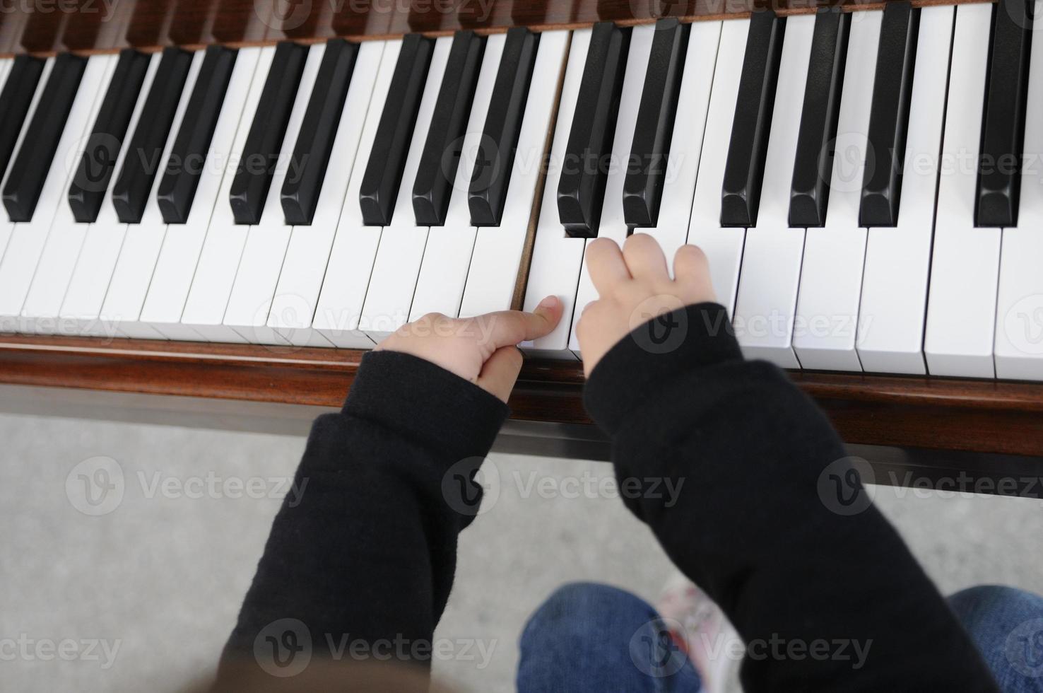 petite fille s'amusant à jouer du piano photo