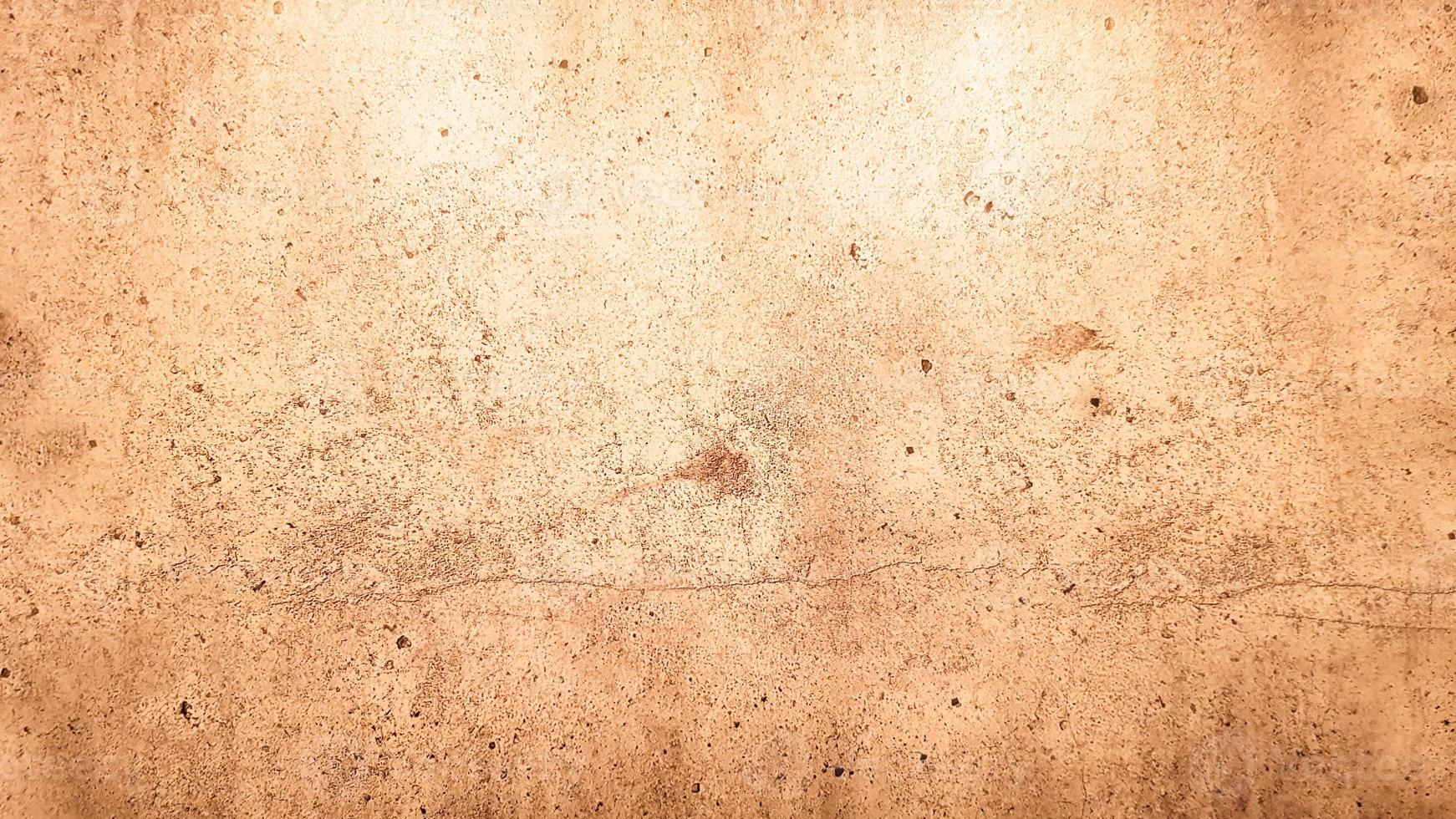 texture de pierre de granit. fond de pierre dorée brune. ancienne surface de mur de pierre vide ou ancien fond de texture de papier brun sale marron ou beige. grunge d'or brun. photo
