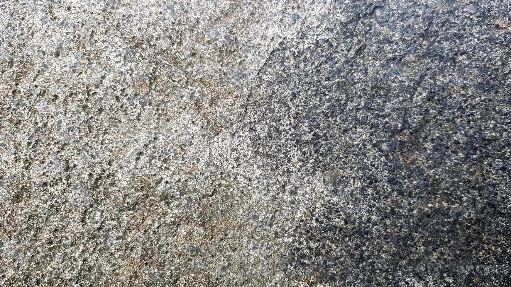 texture ou fond de pierre. structure en pierre fissurée grossière du visage. texture ou fond de pierre grise vide photo