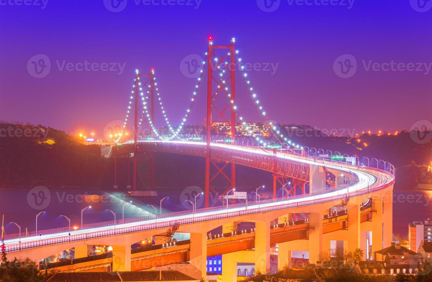 vue sur le pont du 25 avril - ponte 25 de abril avec sentiers lumineux de voiture dans la brume. point de repère populaire de lisbonne, portugal photo