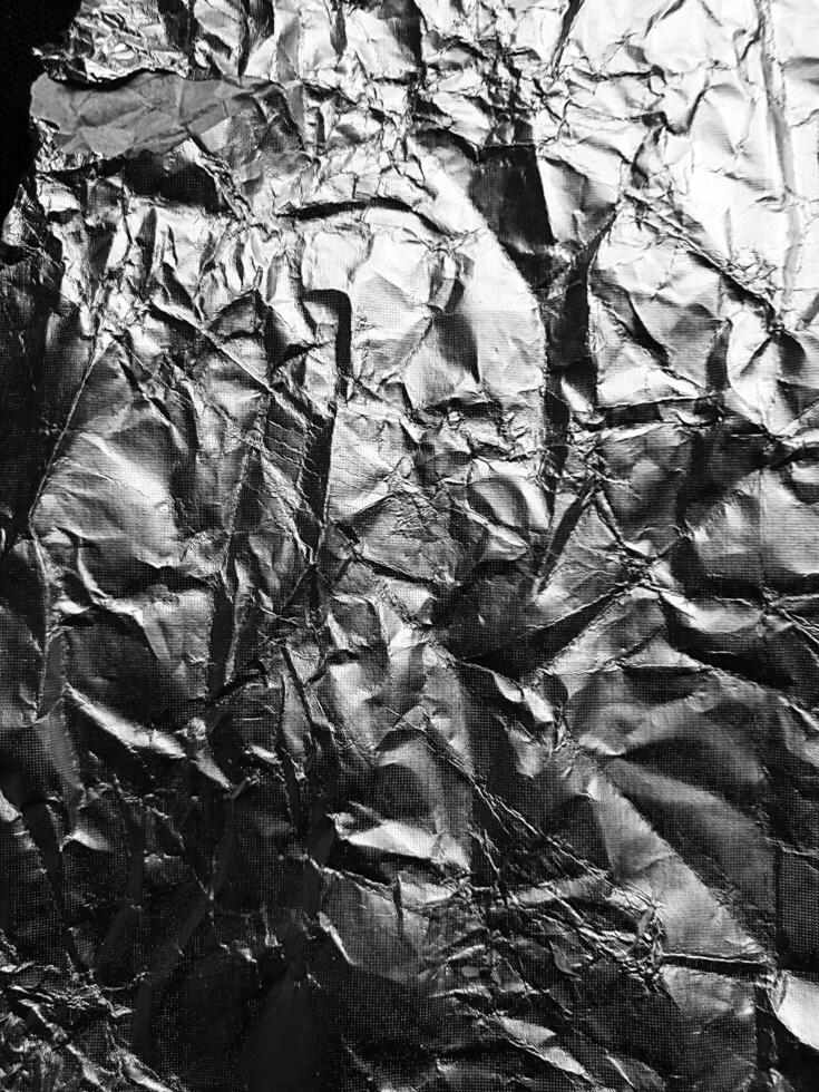 la surface de la texture du papier d'aluminium pour les matériaux d'arrière-plan et de conception. collection de texture froissée de feuille d'argent. abstrait froissé de fond. photo