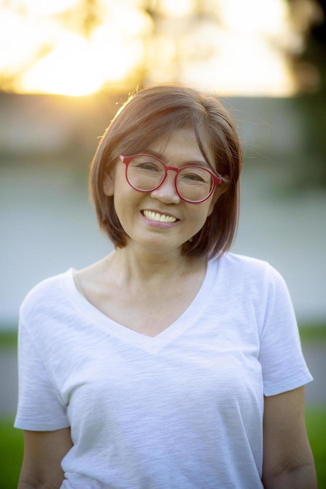 visage souriant à pleines dents d'une femme en bonne santé debout en plein air avec des vêtements décontractés photo