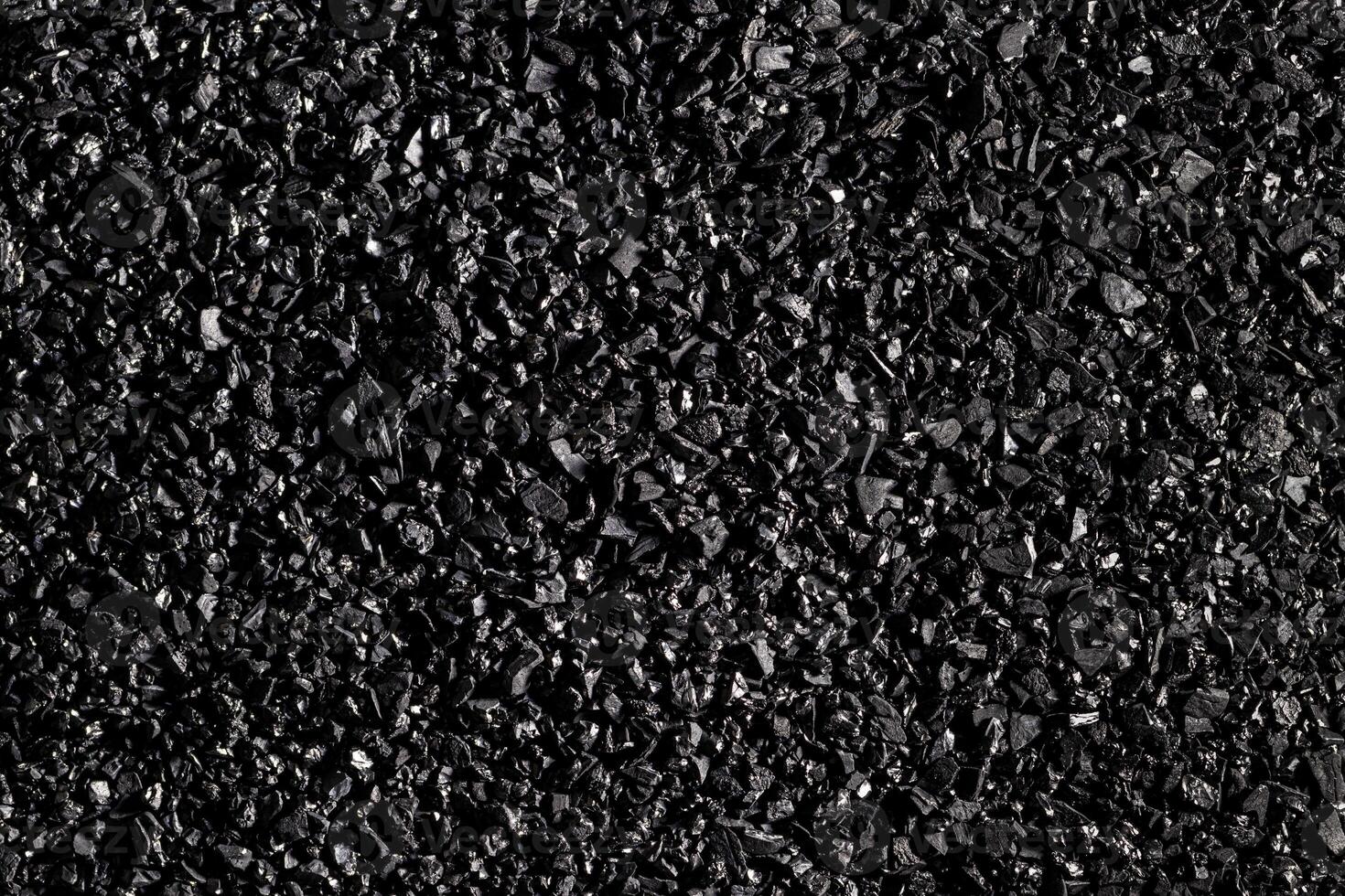 fermer activé carbone texture. noix de coco charbon. photo