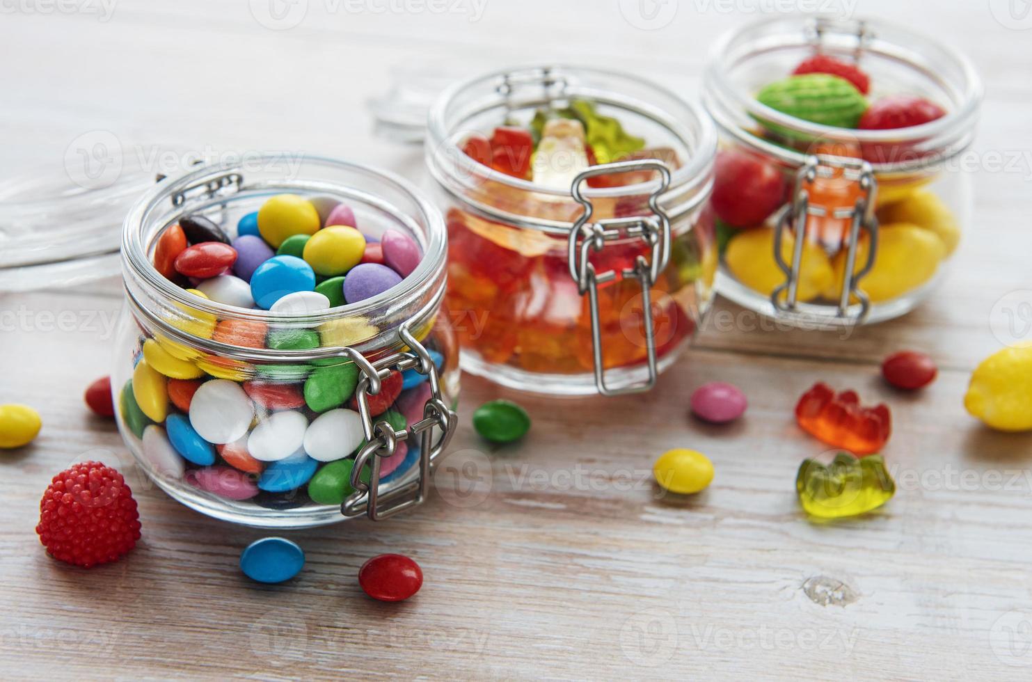 Bonbons colorés en pots sur table photo