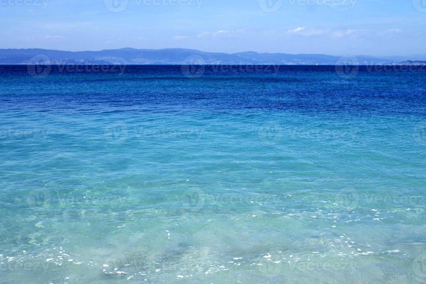 vert et bleu de la mer et bleu ciel belle mer et coucher de soleil avec un grand soleil jaune sous les collines de la surface de la mer en arrière-plan. photo