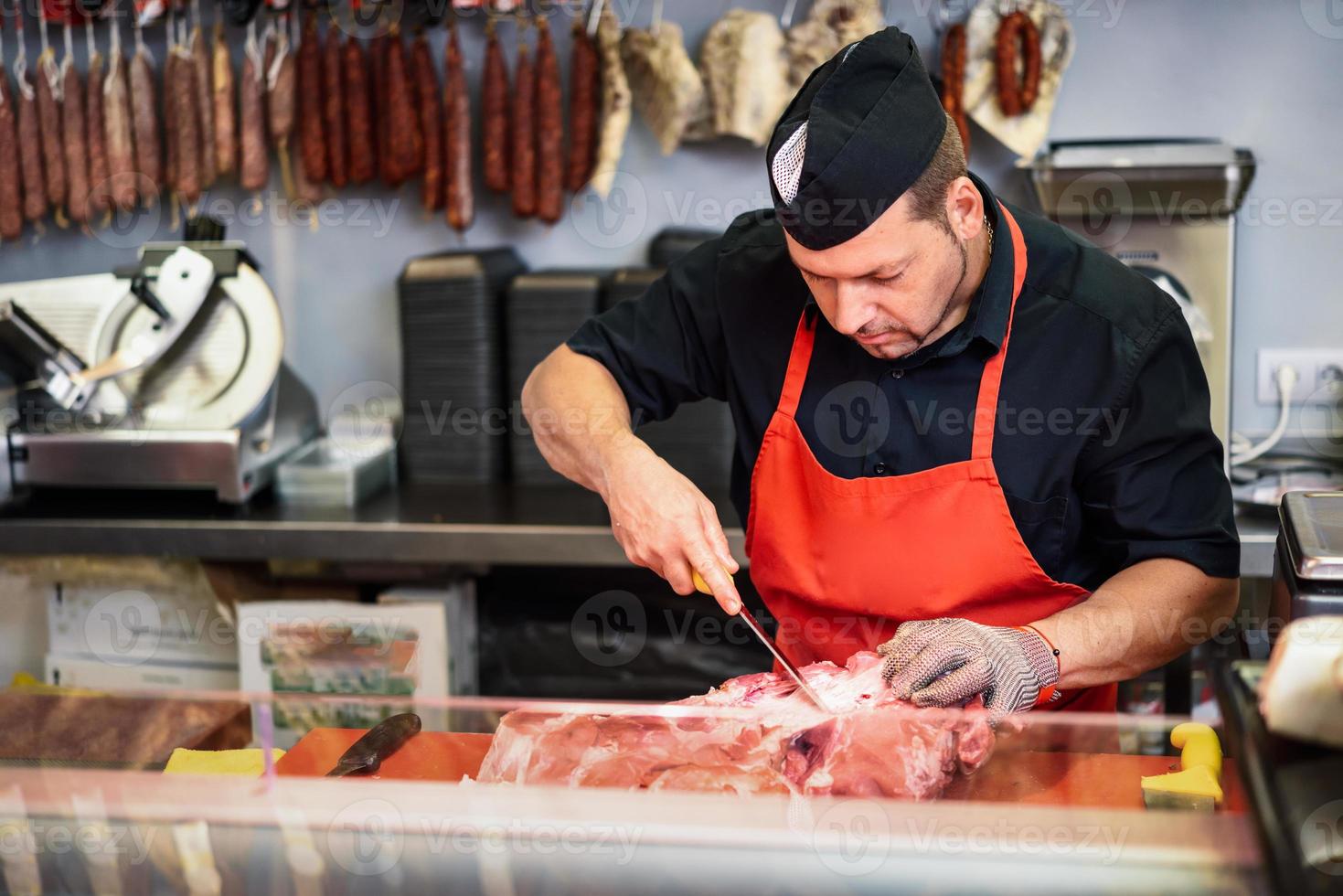 Jambon frais désossage de boucher dans une boucherie moderne photo