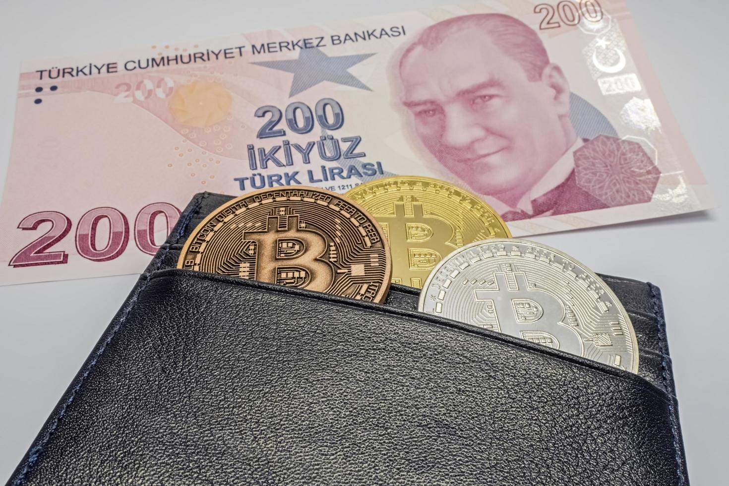 Istanbul, turquie-décembre 24,2021.pièces de monnaie bitcoin dans un portefeuille noir avec billet de banque en papier-monnaie en monnaie photo