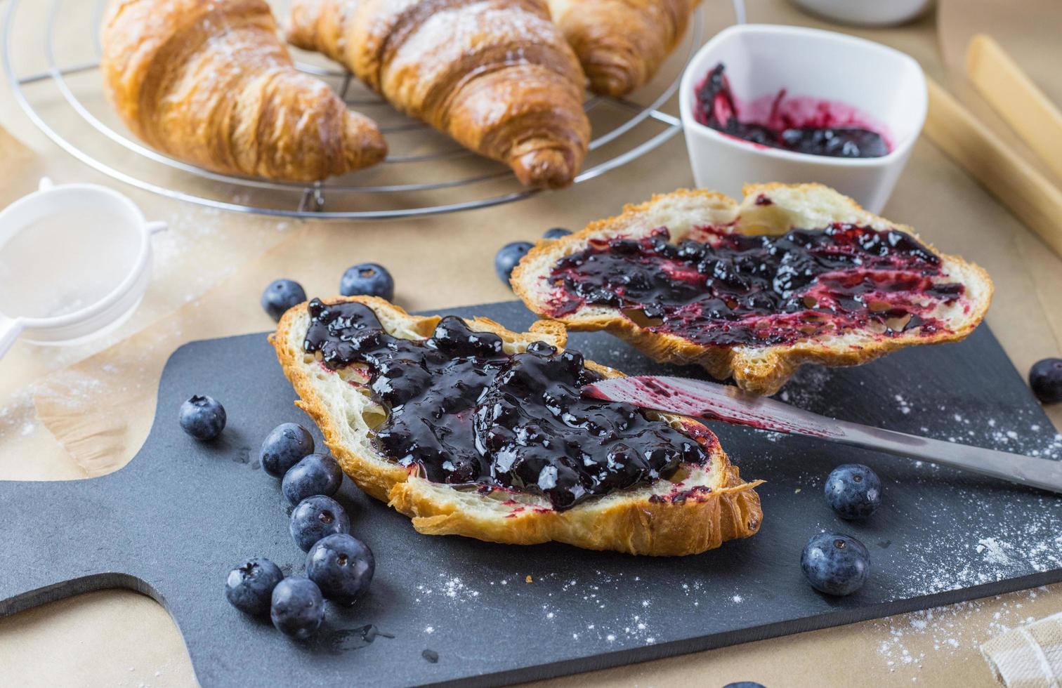 croissants français avec confiture de myrtilles et fruits. photo en gros plan