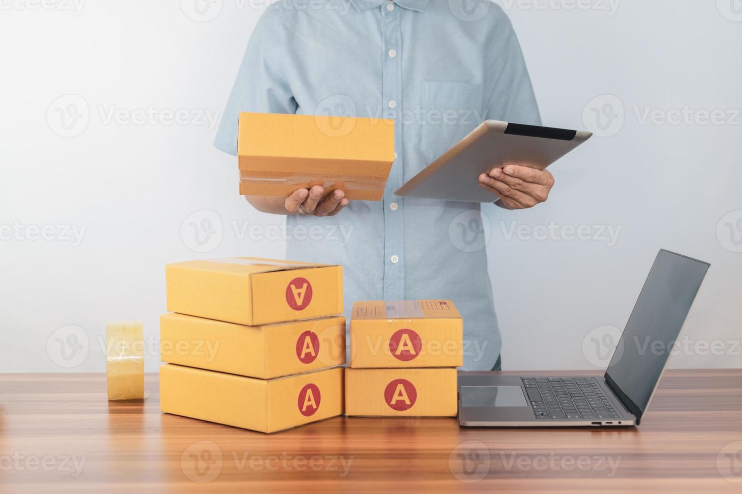 l'homme utilise une tablette pour vérifier la commande pour la vente d'une boutique en ligne photo