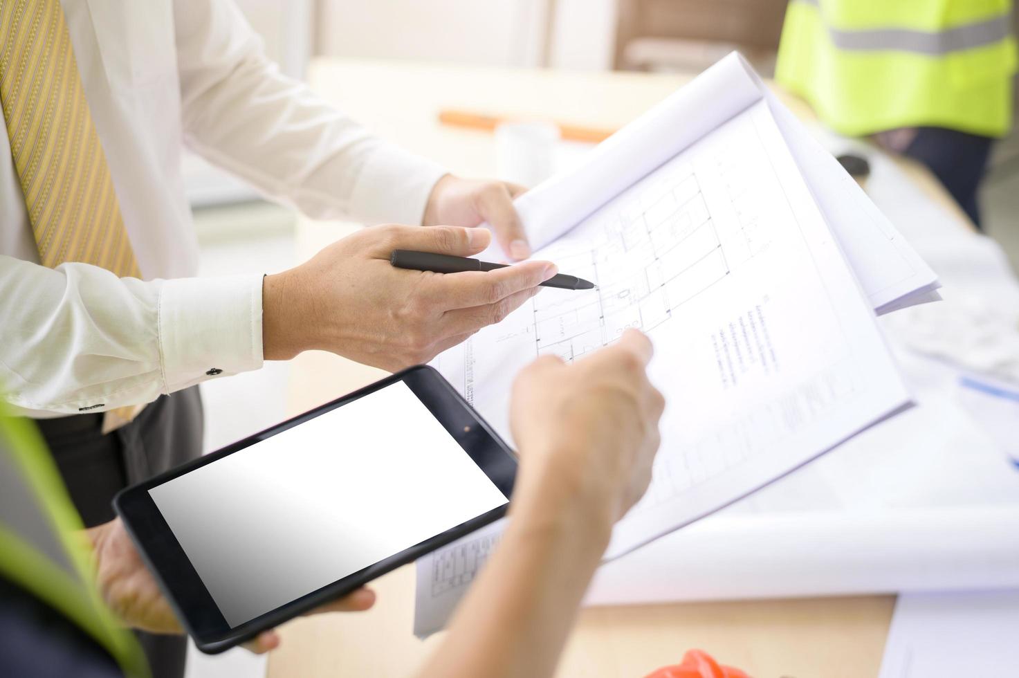 les ingénieurs en gros plan sont des plans de construction analytiques avec un plan au bureau photo