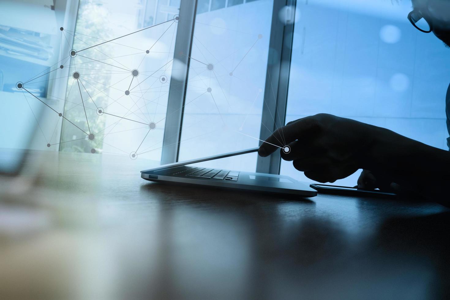 gros plan sur une main d'homme d'affaires travaillant sur un ordinateur portable sur un bureau en bois photo