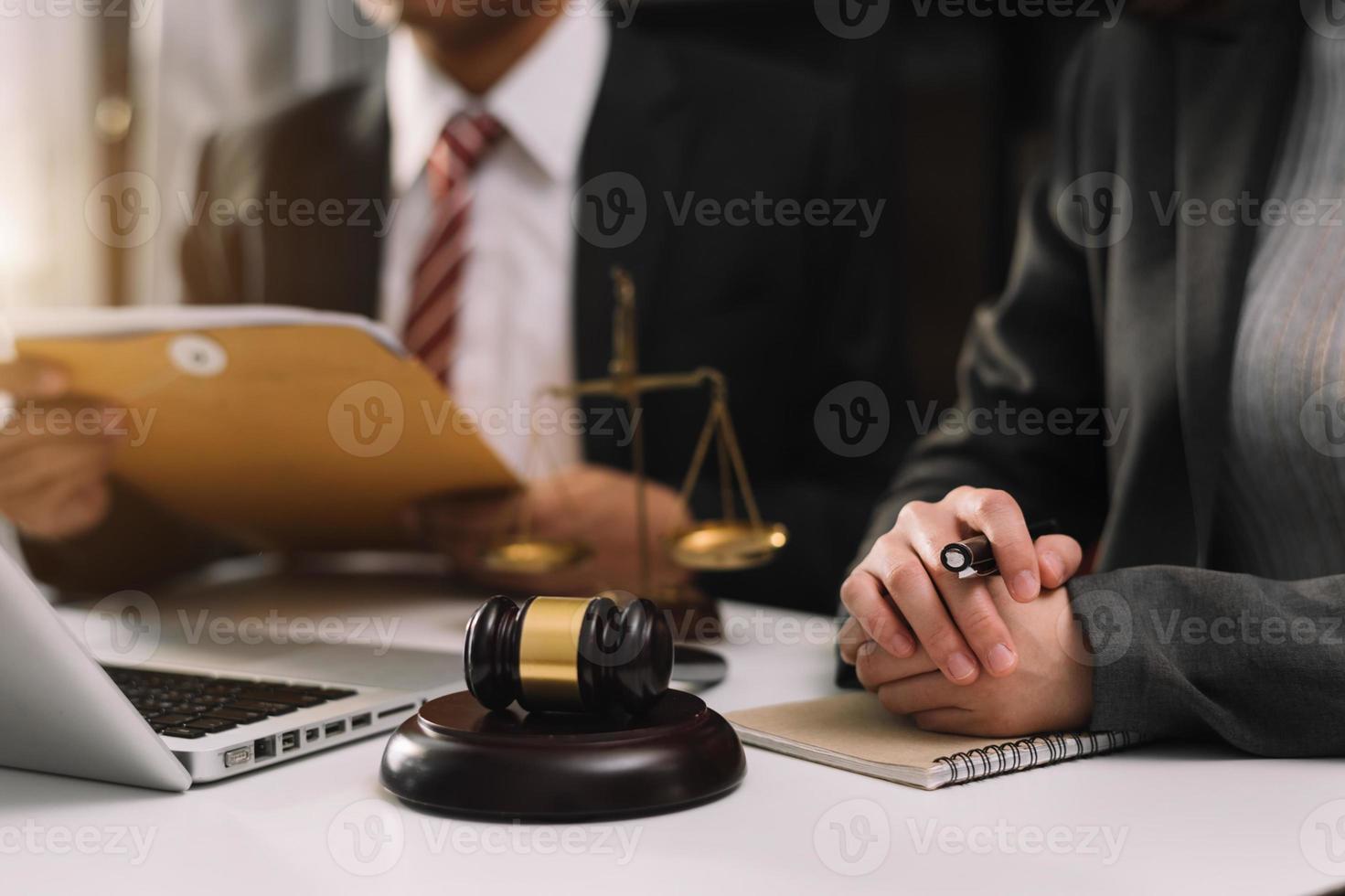 entreprises et avocats discutant des documents contractuels avec une balance en laiton sur le bureau du bureau. droit, services juridiques, conseils, justice et concept de droit. photo