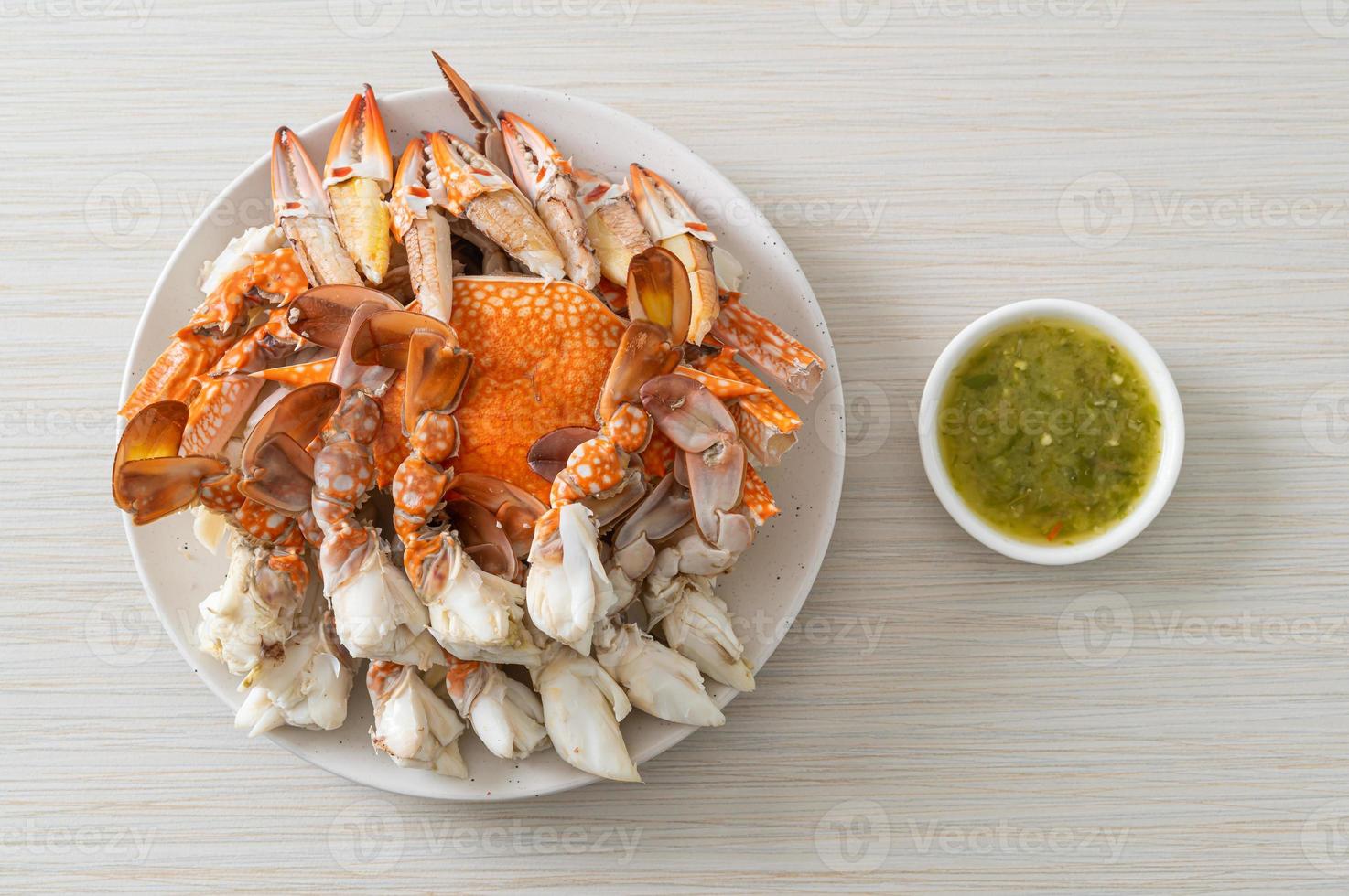 crabe bleu cuit à la vapeur avec sauce épicée aux fruits de mer photo