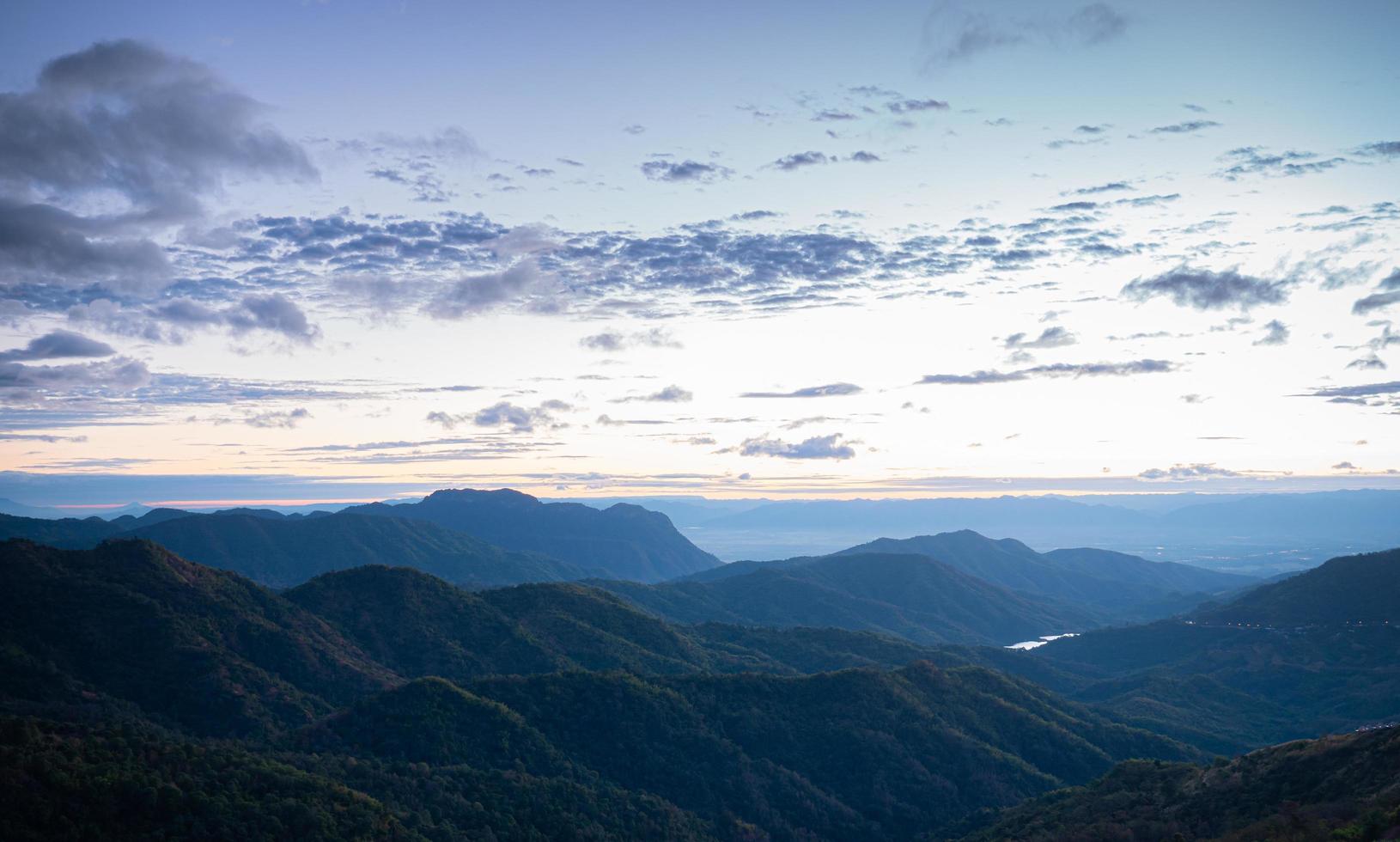 paysage de montagne complexe le matin le soleil se lève et la lumière du soleil le matin, une légère brume au sommet de la montagne photo