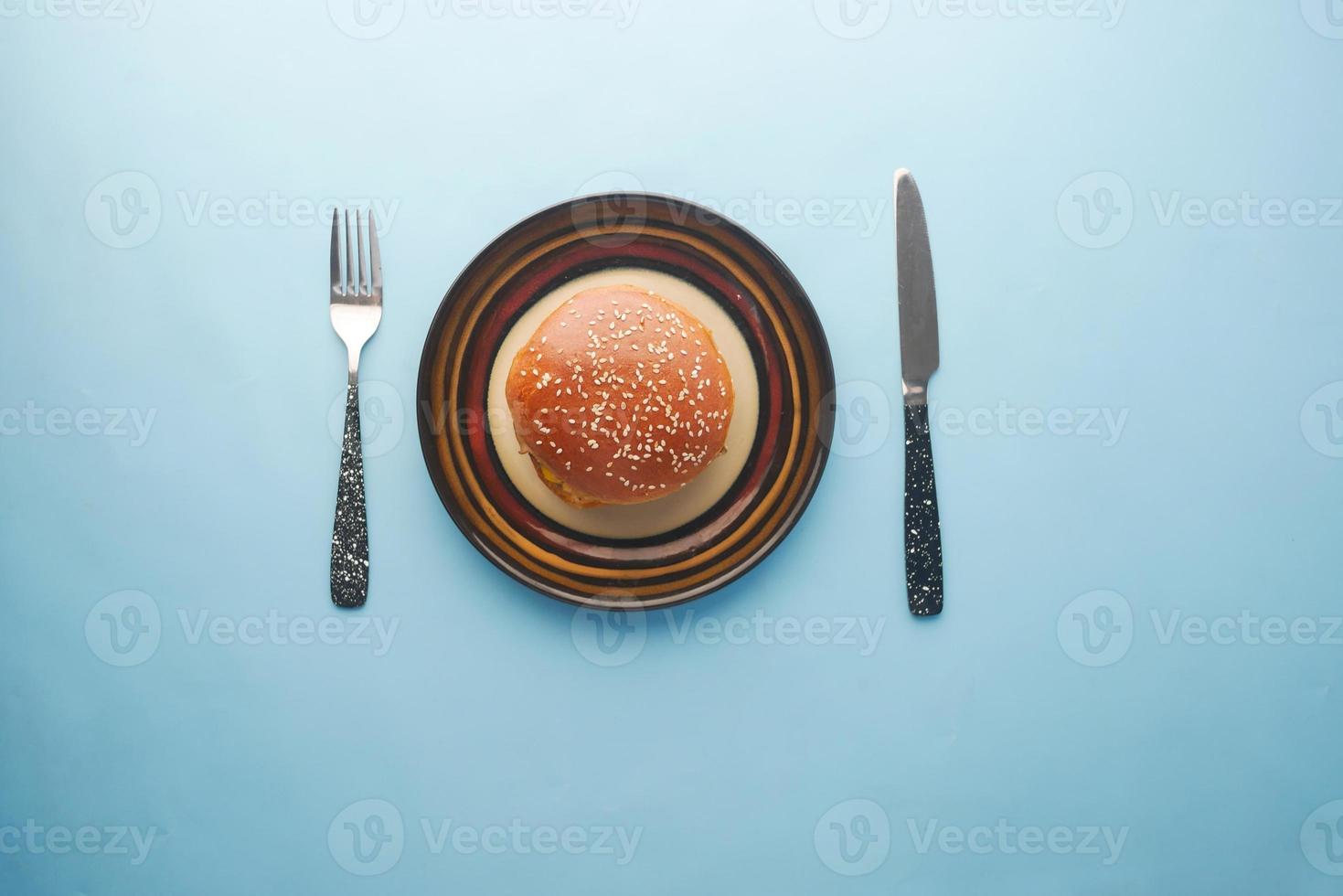 vue de dessus du burger sur une assiette avec un couteau et une fourchette photo