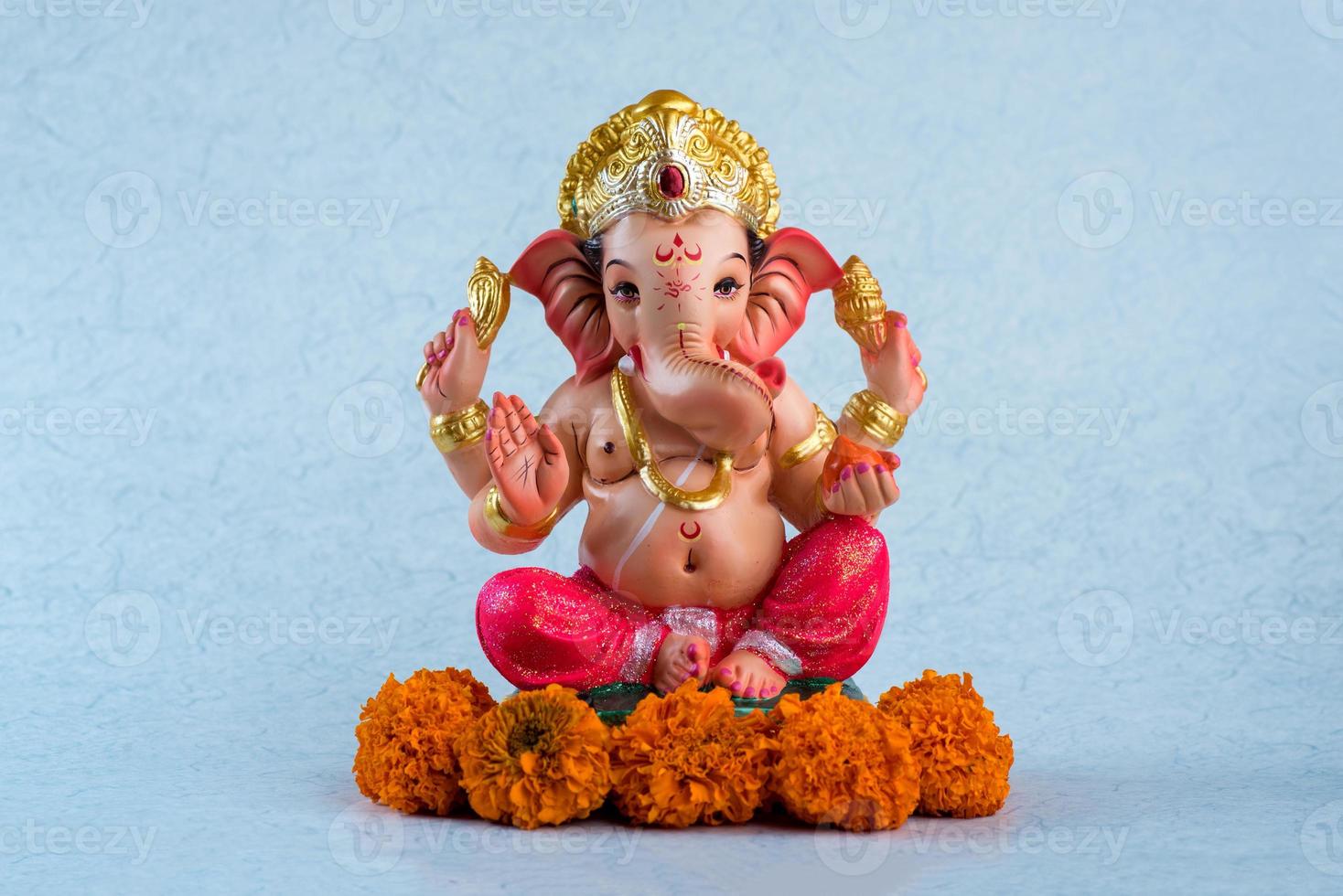 dieu hindou ganesha. idole de ganesha sur fond bleu. photo