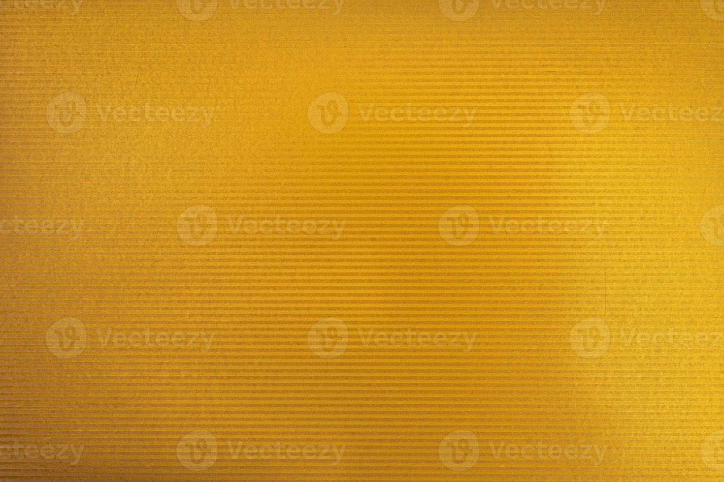 texture de carton de couleur dorée. paillettes de couleur dorée avec lumière photo