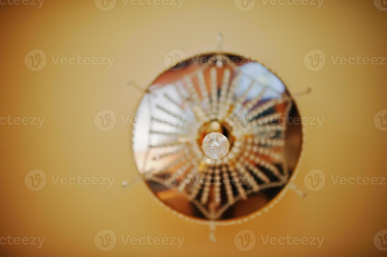 lustre doré et miroir sur plafond orange. mise au point douce photo