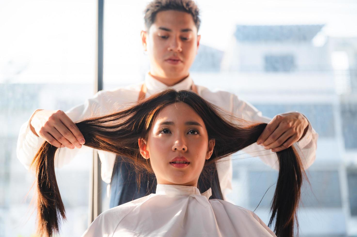 coiffeur et belle cliente faisant des soins de santé des cheveux de traitement dans un salon de style de mode photo