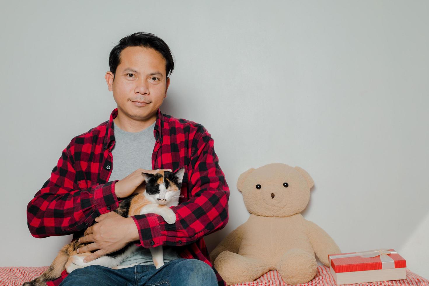 l'homme a utilisé sa main pour caresser la tête du chat comme lui. photo