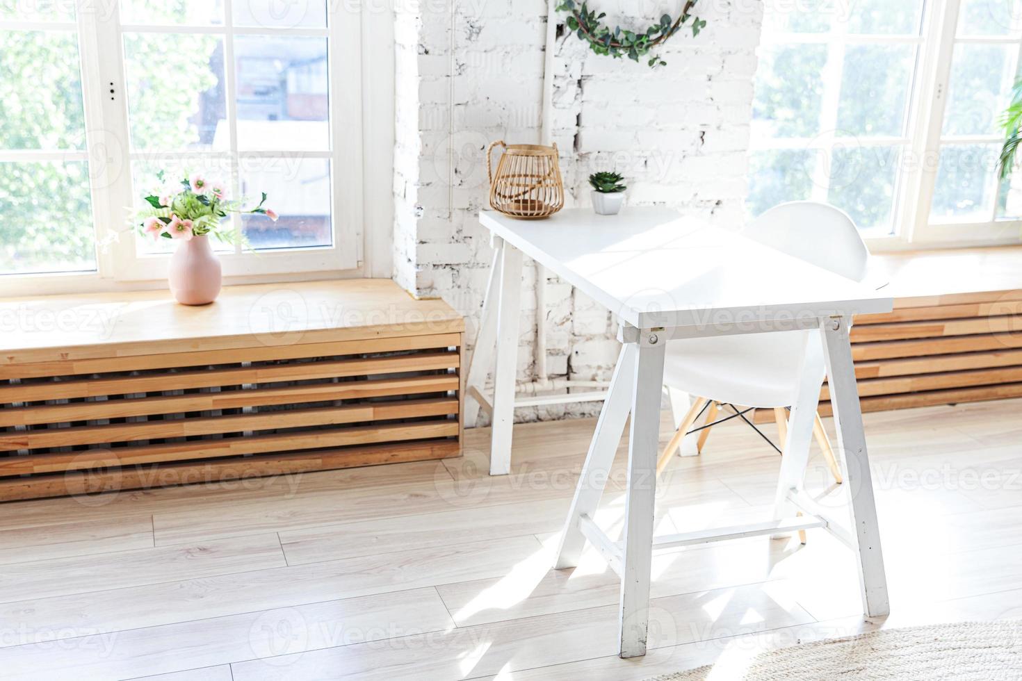 intérieur de bureau à la maison moderne loft élégant. appartement design spacieux avec des murs clairs, de grandes fenêtres et un bureau. décoration moderne et épurée avec un mobilier élégant de style scandinave minimaliste. photo