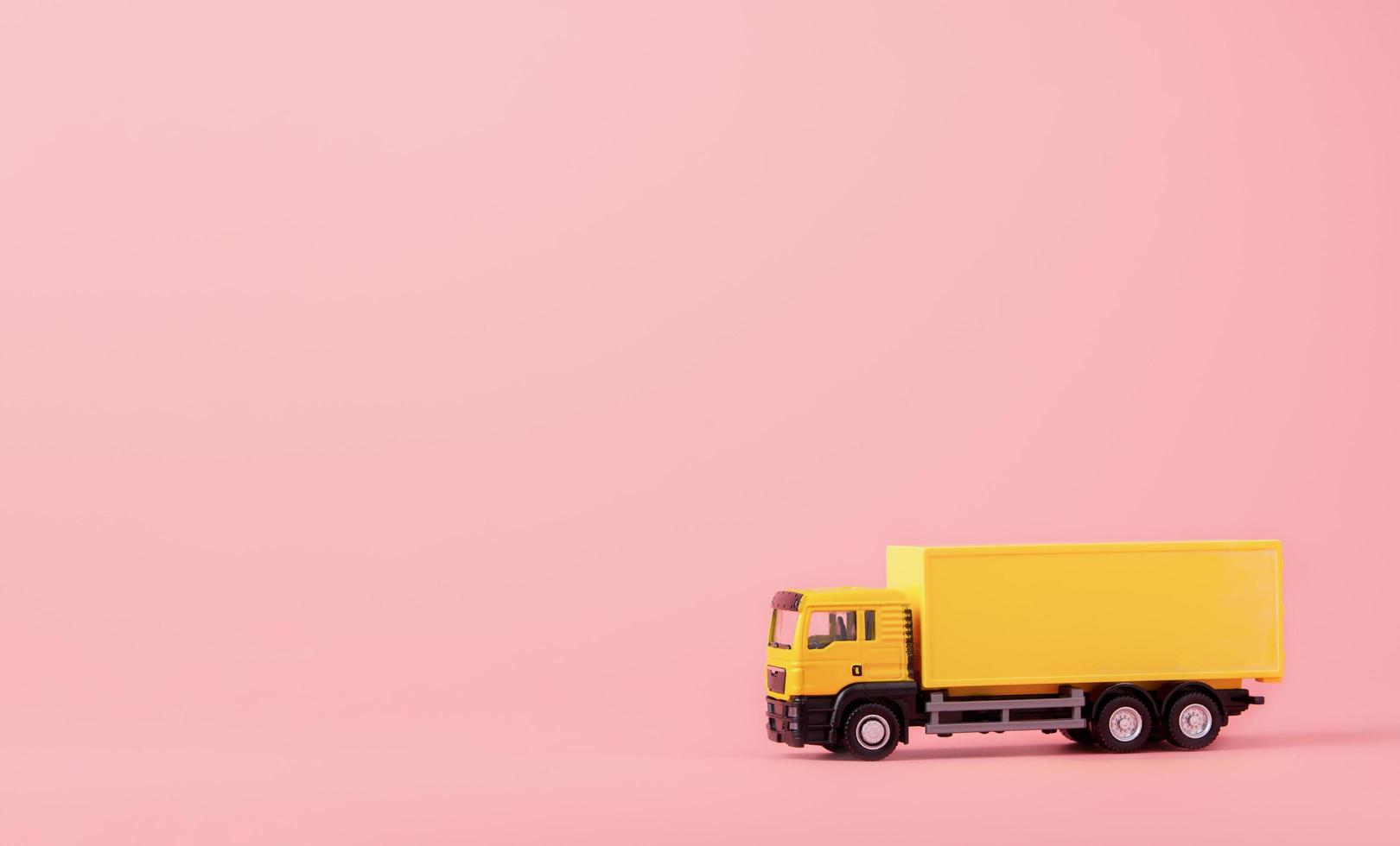 logistique et service de livraison - camion cargo et sur fond rose. service d'achat sur le web en ligne et propose la livraison à domicile. avec espace de copie photo