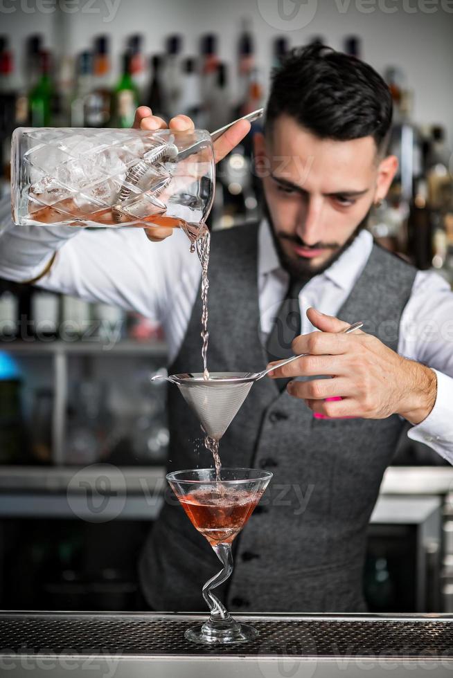 barman remplissant un verre de cocktail photo