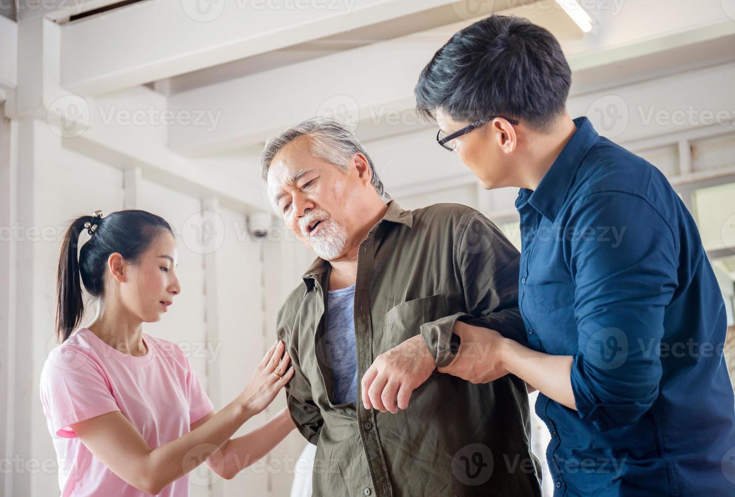 fils et fille aident à soutenir un père âgé qui a mal au dos, mal au dos chez les personnes âgées, concepts de famille asiatique photo