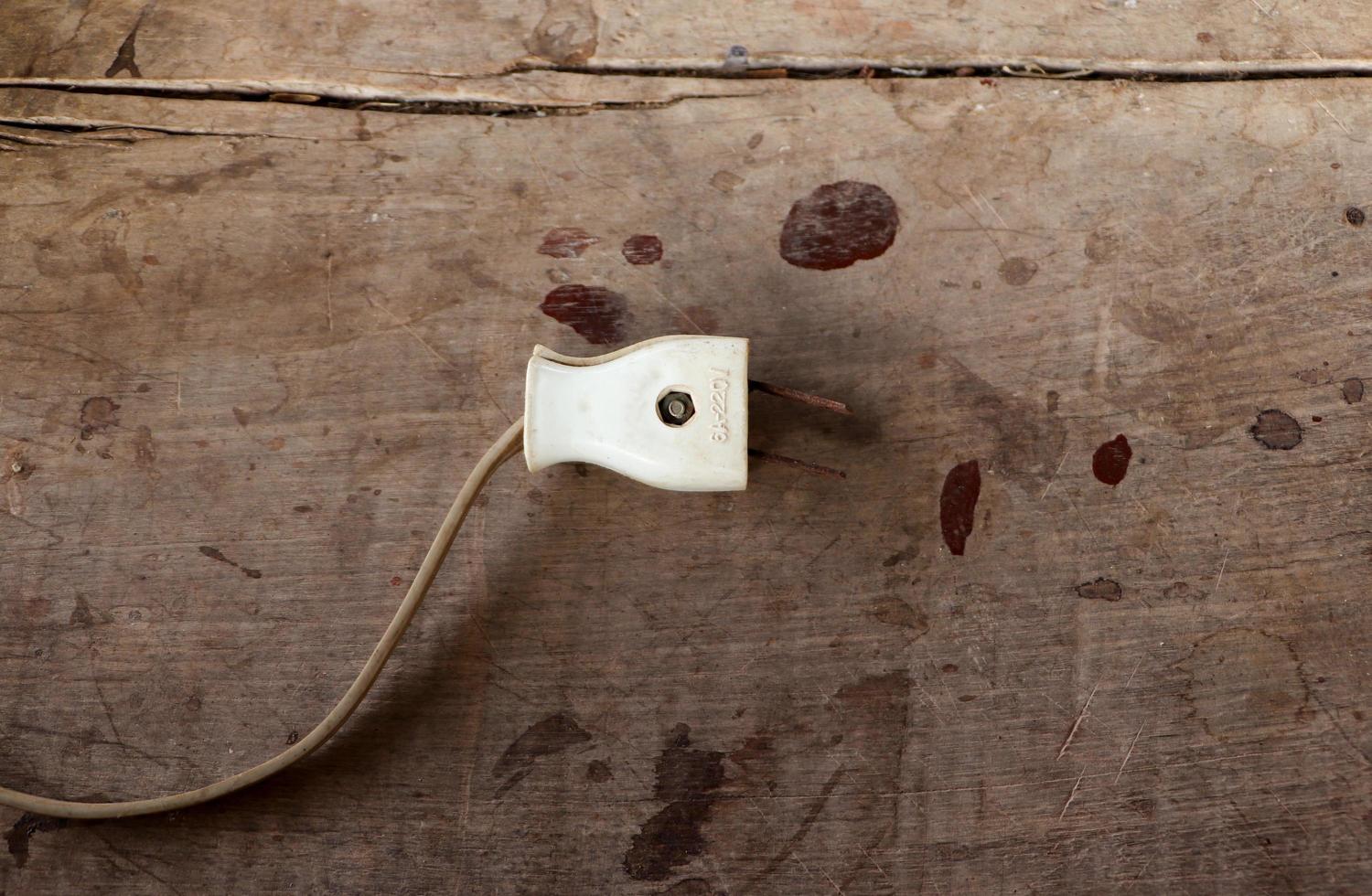 Vieux dispositif de prise électrique usé sur table en bois photo