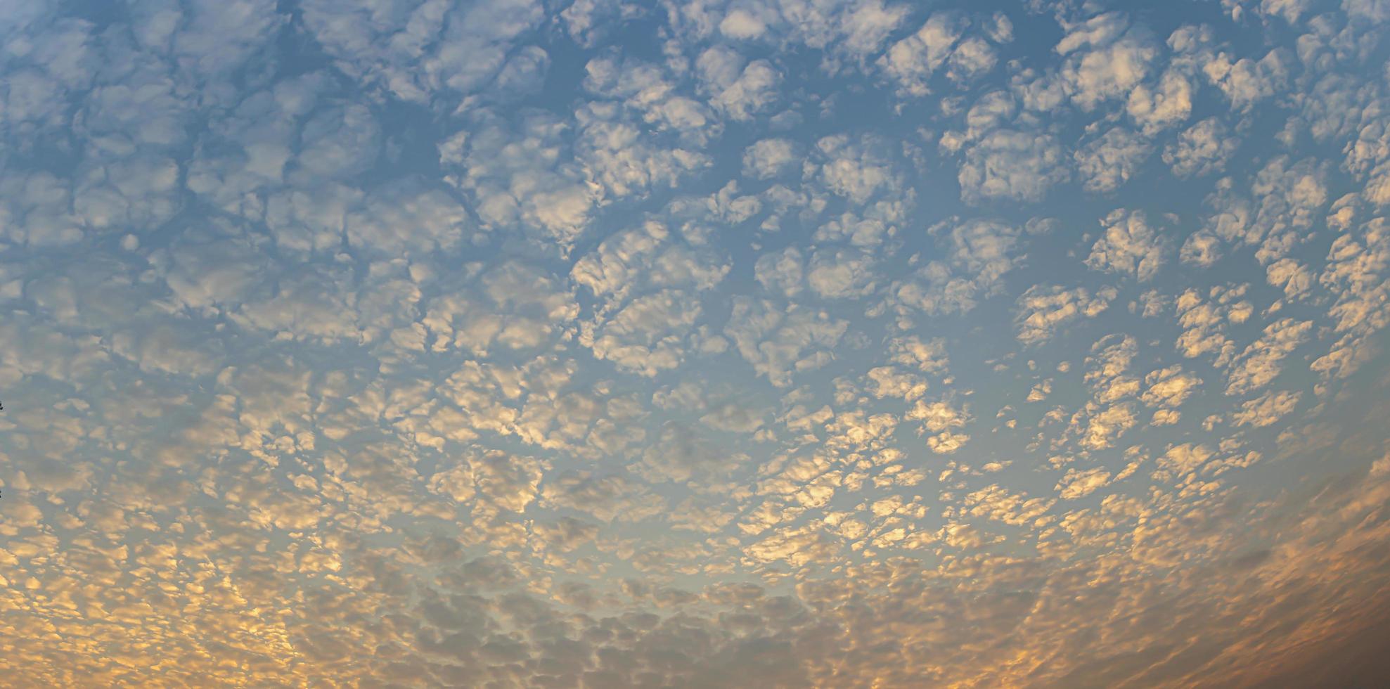 le ciel coucher de soleil panorama est magnifique en orange, les nuages s'étalent en cubes. photo