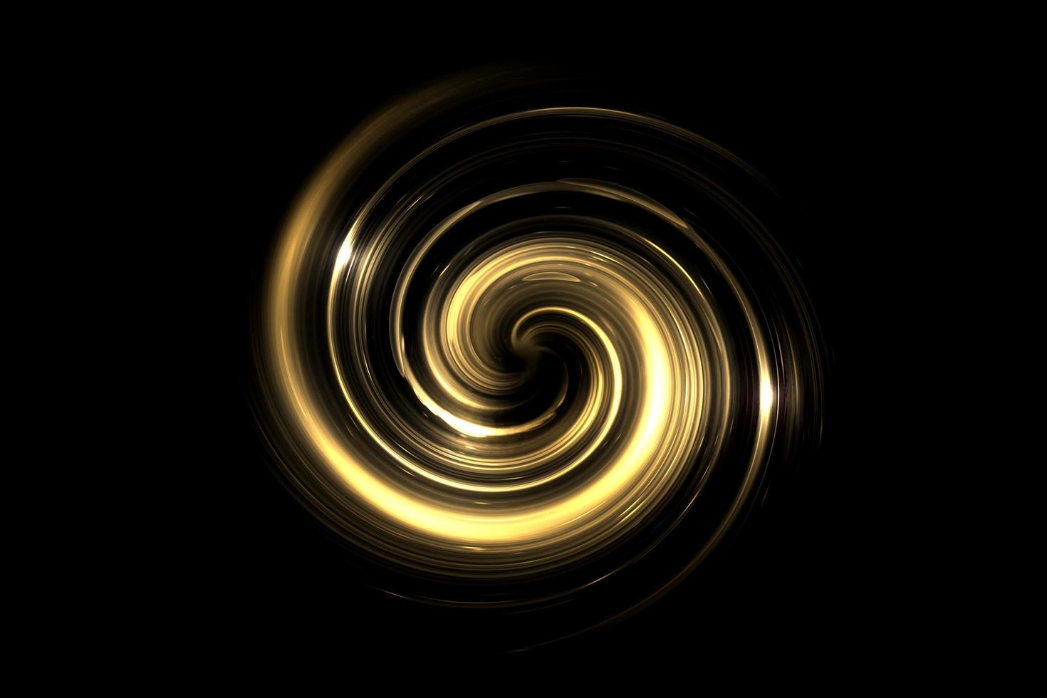 Vortex doré brillant abstrait avec anneau lumineux sur fond noir photo