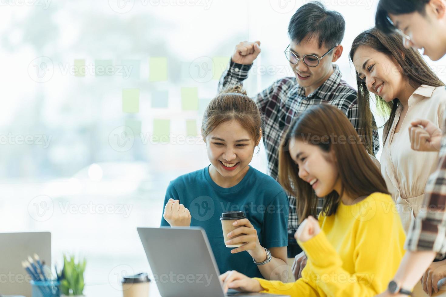 succès et concept gagnant, équipe commerciale asiatique heureuse célébrant la victoire au bureau. photo