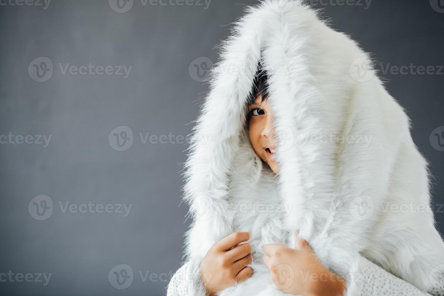 mignon garçon portant des vêtements d'hiver pendant la saison d'hiver photo